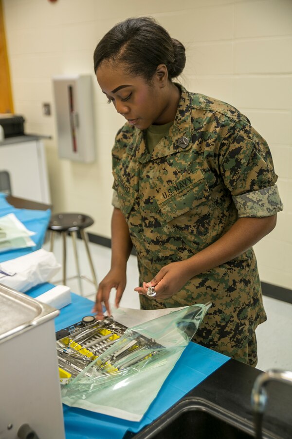 Petty Officer 3rd Class Carlotta Howard, a dental corpsman with 4th Dental Battalion, 4th Marine Logistics Group, Marine Forces Reserve, packages dental extraction tools to be sterilized for use during Innovative Readiness Training Louisiana Care 2017 at East St. John High School in Reserve, La., July 12, 2017. This year’s IRT builds mutually beneficial civil-military partnerships between local communities to provide high quality, mission-essential training for service members and their units. (Photo by U.S. Marine Pvt. Samantha Schwoch/Released) 