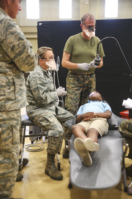 Air Force National Guardsmen and U.S. Navy personnel conduct a dental examination during Innovative Readiness Training Louisiana Care 2017 at Assumption Community Center in Napoleonville, La., July 12, 2017. The Louisiana Care Innovative Readiness Training event is a joint-service medical mission that provides the military with hands-on readiness training opportunities, while at the same time providing direct and lasting benefits to the residents of Louisiana. (Photo by U.S. Marine Pvt. Samantha Schwoch/ Released)