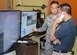 Staff Sgt. Alexander Deguzman, 412th Security Forces Squadron installation security technician, shows Bobby Truong, 412th Communications Squadron, the monitors and controls of the Raptor surveillance system that was demonstrated to base leadership July 10. (U.S. Air Force photo by Kenji Thuloweit)