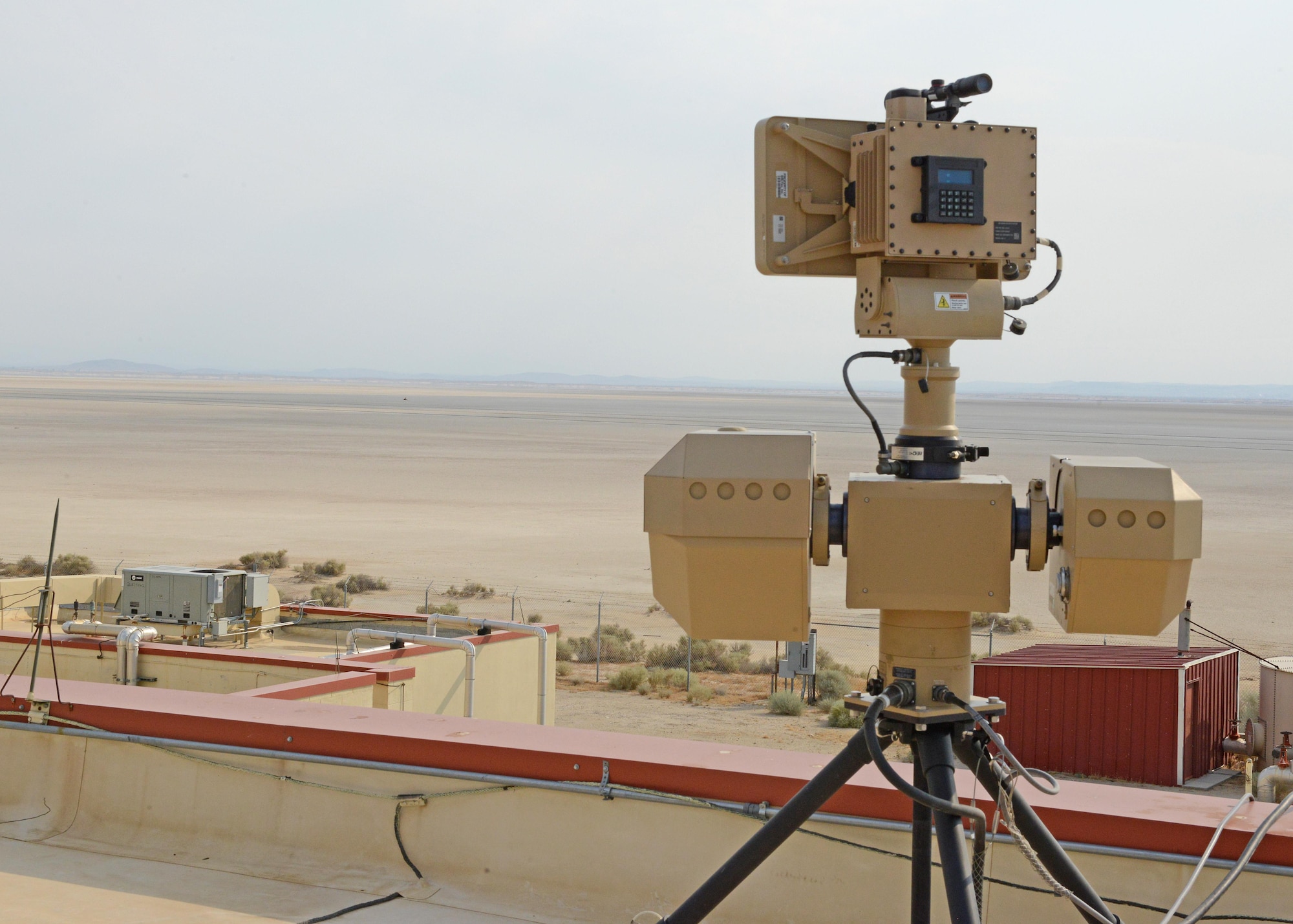 A surveillance system sits on top of a remote building at Edwards. The system was demonstrated to base leadership and 412th Security Forces Squadron personnel July 10. The ground-based radar system has the capability to monitor the lakebed at great distances with electro-optical and infrared sensors. (U.S. Air Force photo by Kenji Thuloweit)