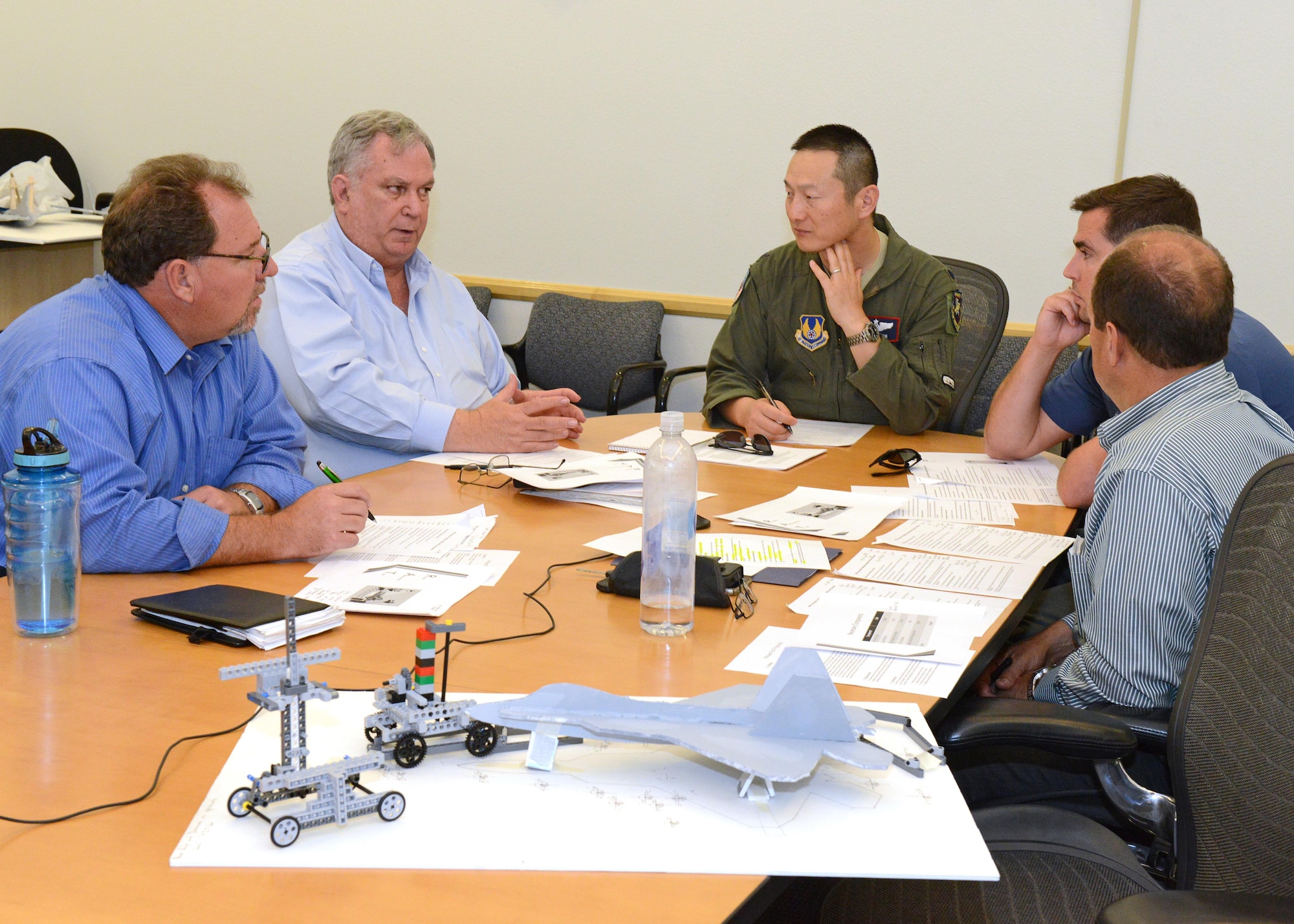 A panel of leaders from various organizations on base decide which one of three design proposals to pursue following presentations at Bldg. 3000. Pictured left to right: Dan Osburn, 412th Test Engineering Group; Peter Burke, 412th Electronic Warfare Group; Lt. Col. Jeffrey Kwok, 412th Operations Group; Kyle Schaller, 771st Test Squadron; and Tony Rubino, 412th Range Squadron. (U.S. Air Force photo by Kenji Thuloweit)