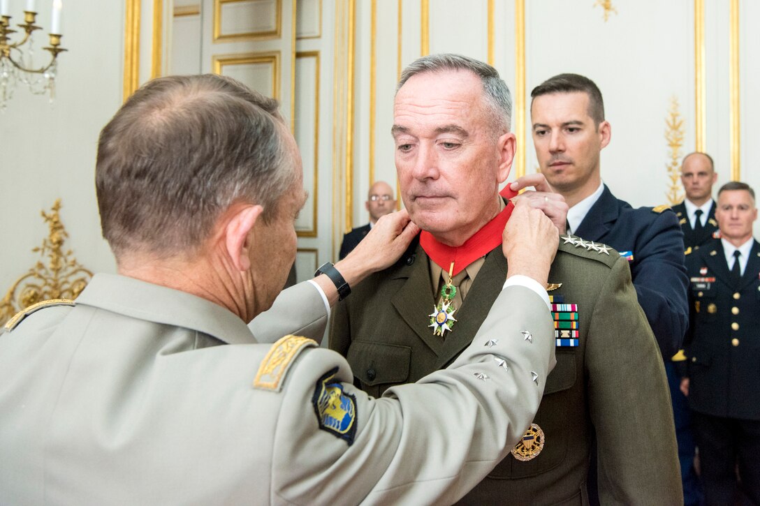 Marine Corps Gen. Joe Dunford, chairman of the Joint Chiefs of Staff, receives the Legion of Honor from French Gen. Pierre de Villiers, chief of the French defense staff, on the eve of Bastille Day in Paris, July 13, 2017. DoD photo by Navy Petty Officer 2nd Class Dominique A. Pineiro