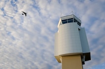 A B-52H Stratofortress flies above the Air Traffic Control Tower at Minot Air Force Base, N.D., June 20, 2017. During any in-flight emergency, it’s an air traffic controller’s responsibility to get the aircraft safely on the ground by clearing the airspace, communicating with the aircrew and ensuring emergency personnel are prepared to meet the aircraft when it lands. (U.S. Air Force photo by Senior Airman Sahara L. Fales)