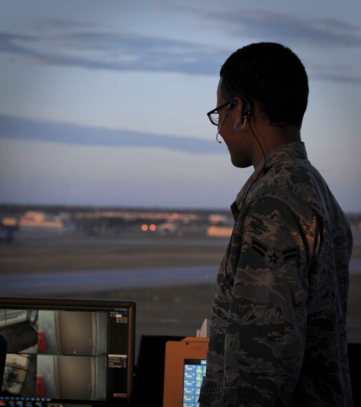 Airman 1st Class Malcolm Blair, 5th Operations Support Squadron air traffic control apprentice, watches a B-52H Stratofortress land at Minot Air Force Base, N.D, June 20, 2017. In addition to their extensive technical school training, air traffic control Airmen are required to complete their Control Tower Operator Certification and train on the simulator to prepare for any situation that may arise. (U.S. Air Force photo by Senior Airman Sahara L. Fales)
