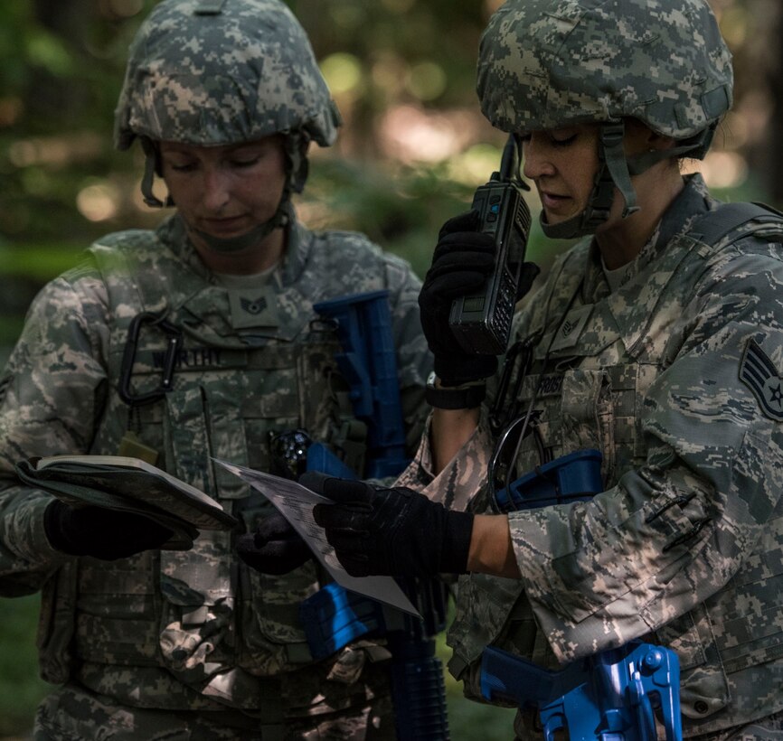 Staff Sgt. Nicole Frost, with assistance from Staff Sgt. Danielle Worthy, calls in information about a possible improvised explosive device during training July 9, 2017, Scott Air Force Base, Illinois. After gathering what intel they find, Frost called in various information about the location of the the device  and a description that will help the Explosive Ordnance Disposal team better defuse the possible threat.  (U.S. Air Force photo by Tech. Sgt. Christopher Parr)