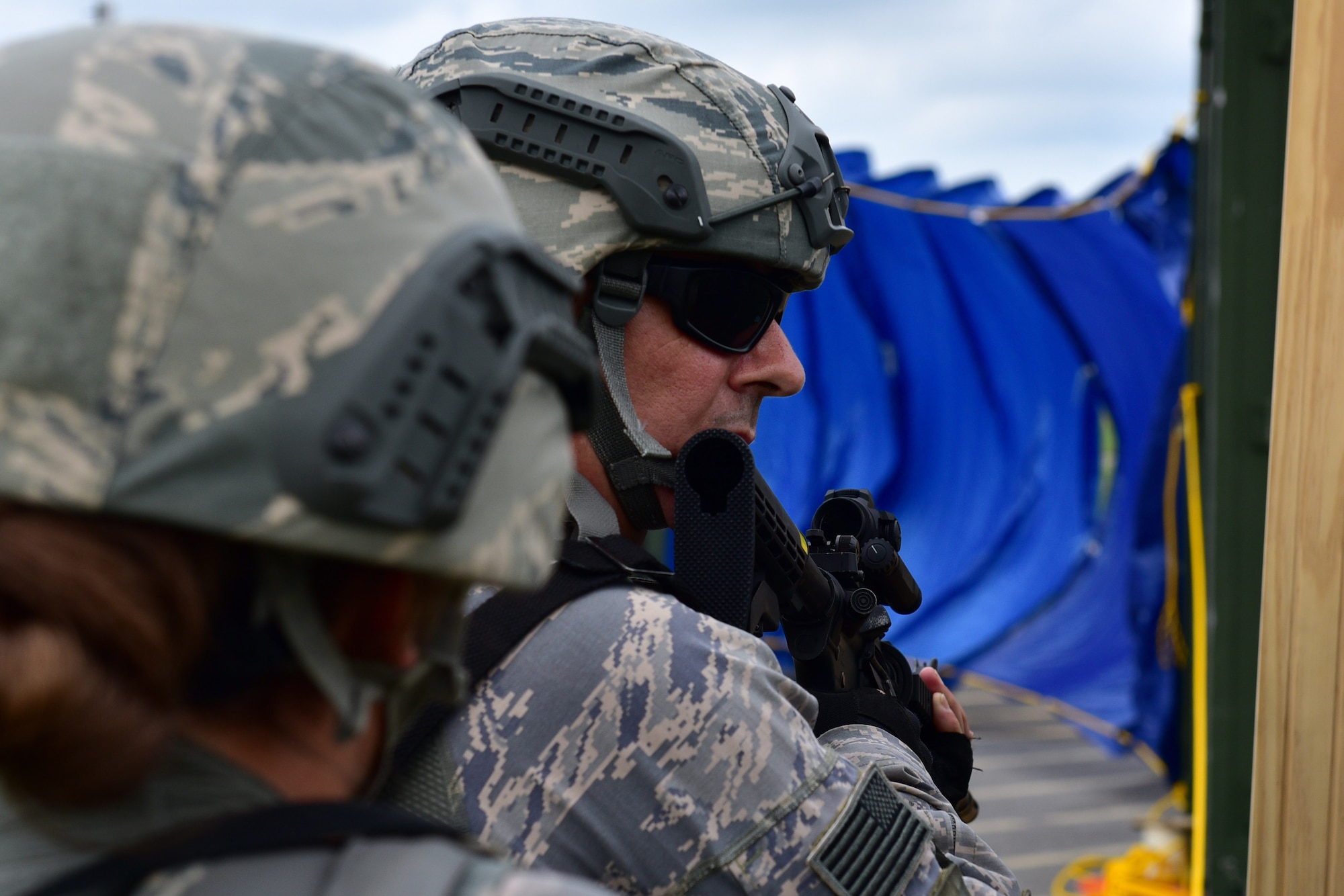 A member of the 914th Security Forces Squadron prepares to enter a simulated building during a training exercise Wednesday, July 13, 2017, Niagara Falls Air Reserve Station, N.Y.The exercise is part of a "shoot-move-communicate" annual training to test SFS members' readiness. (U.S. Air Force photo by Staff Sgt. Richard Mekkri)