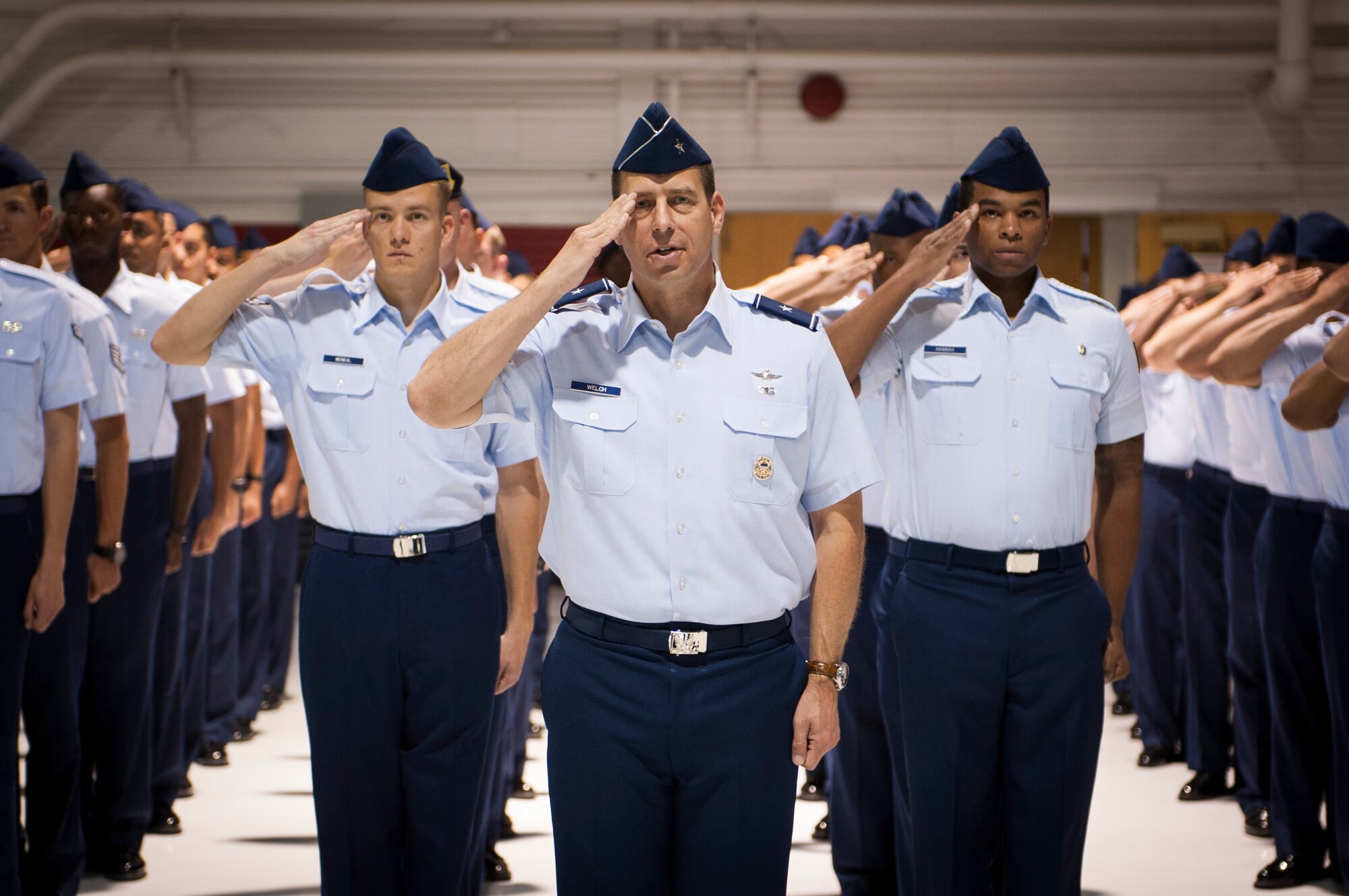 Brig. Gen. Paul Welch, U.S. Air Force Warfare Center vice commander, leads a formation comprised of Airmen representing various units across Nellis Air Force Base in rendering a traditional first salute during a change of command ceremony July 13, 2017, at Nellis AFB, Nev. The USAFWC exists to ensure deployed forces are well trained and well equipped to conduct integrated combat operations. (U.S. Air Force photo by Senior Airman Joshua Kleinholz)