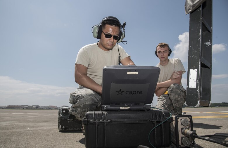 U.S. Air Force Staff Sgt. Sonethasinh Sayasaeng, left, shows Airman 1st Class Talon Cotterman, right, both 35th Maintenance Squadron avionics technicians, how to begin the M7.1 upgrade to an F-16 Fighting Falcon at Misawa Air Base, Japan, July 13, 2017. Both aircraft maintenance unit personnel are working together to simultaneously phase the 13th and 14th Fighter Squadrons’ fleet into the new upgrade by Aug. 1, enabling emerging pilots to receive a finer quality of training. (U.S. Air Force photo by Airman 1st Class Sadie Colbert)