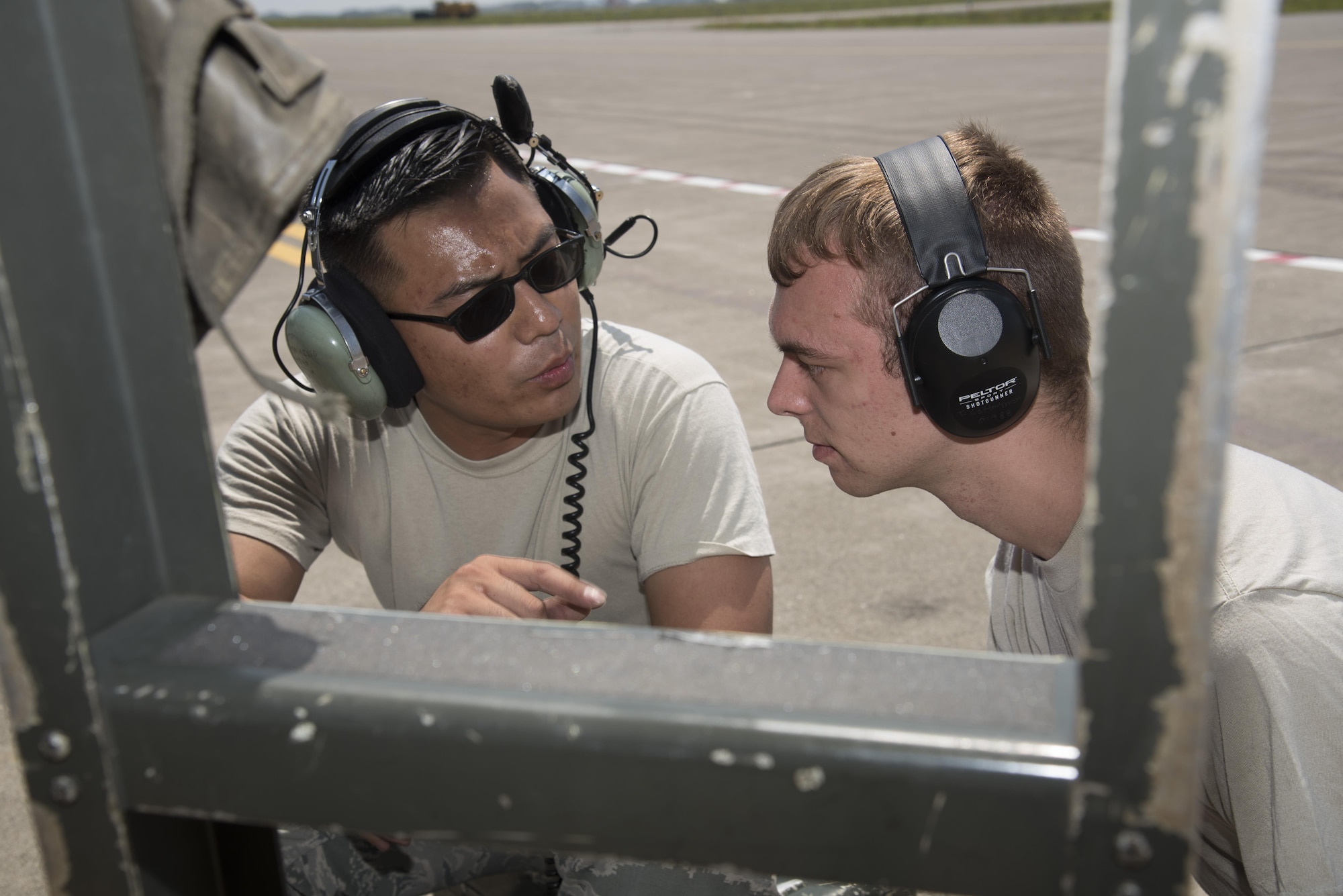 U.S. Air Force Staff Sgt. Sonethasinh Sayasaeng, left, shows Airman 1st Class Talon Cotterman, right, both 35th Maintenance Squadron avionics technicians, how to install the M7.1 upgrade to an F-16 Fighting Falcon at Misawa Air Base, Japan, July 13, 2017. Misawa is receiving the M7.1, an avionics system upgrade, to further enhance the fleet’s readiness, situational awareness and tactical capabilities, ensuring Misawa provides the highest level of stability in the Indo-Asia- Pacific region and peace of mind for our allies. (U.S. Air Force photo by Airman 1st Class Sadie Colbert)