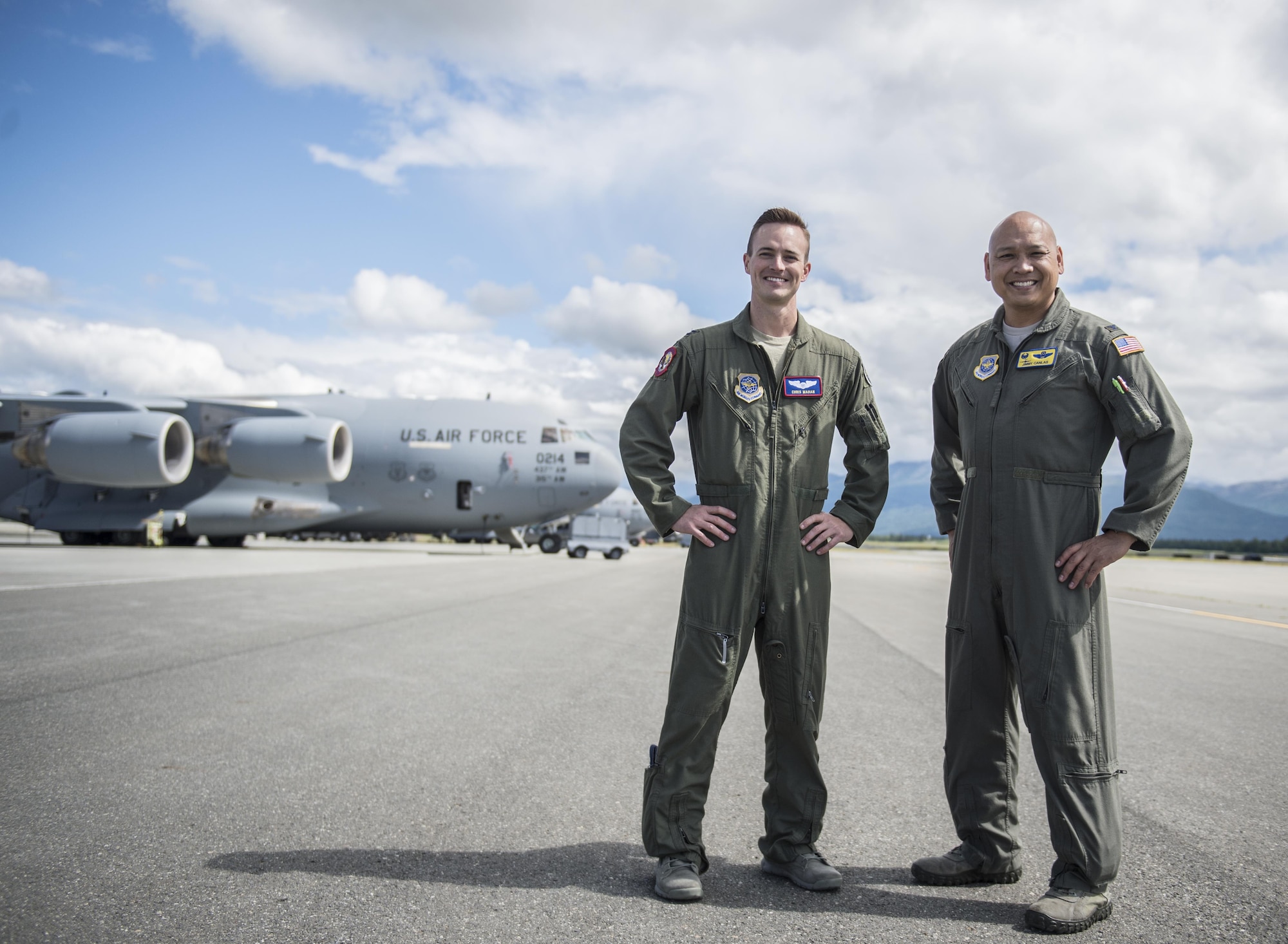 Capt. Chris Mahan (left), pilot, and Col. Jimmy Canlas (right), commander, 437th Airlift Wing pose in front of a U.S. Air Force C-17 from Joint Base Charleston, S.C., on the ramp at Joint Base Elmendorf-Richardson, Alaska, July 9, 2017 after landing to participate in and provide airlift support for Exercise Talisman Saber 2017. The purpose of TS17 is to improve U.S.-Australian combat readiness, increase interoperability, maximize combined training opportunities and conduct maritime prepositioning and logistics operations in the Pacific. TS17 also demonstrates U.S. commitment to its key ally and the overarching security framework in the Indo Asian Pacific region.