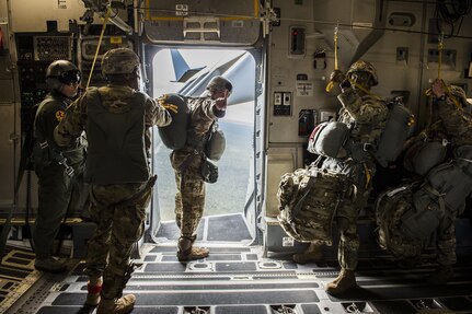 A U.S. Army airborne jumpmaster from the 4th Brigade 25th Infantry division signals "one minute" to drop while he looks out of the open troop door on a U.S. Air Force C-17 Globemaster III from Joint Base Charleston, S.C., July 12, 2017 waiting to airdrop in support of Exercise Talisman Saber 2017. The purpose of TS17 is to improve U.S.-Australian combat readiness, increase interoperability, maximize combined training opportunities and conduct maritime prepositioning and logistics operations in the Pacific. TS17 also demonstrates U.S. commitment to its key ally and the overarching security framework in the Indo Asian Pacific region.