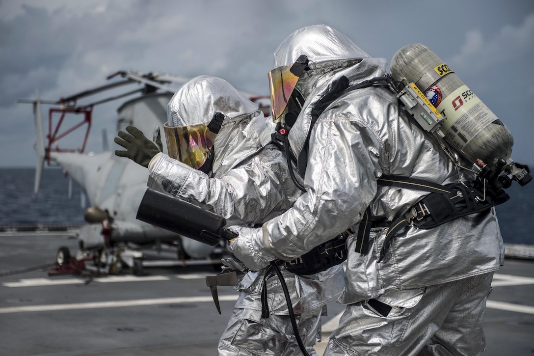 Sailors participate in an aircraft firefighting drill aboard the USS Coronado in the South China Sea, July 11, 2017. The Coronado is patrolling the region's littorals and working hull-to-hull with partner navies to provide the 7th Fleet with the flexible capabilities it needs now and in the future. Navy photo by Petty Officer 3rd Class Deven Leigh Ellis