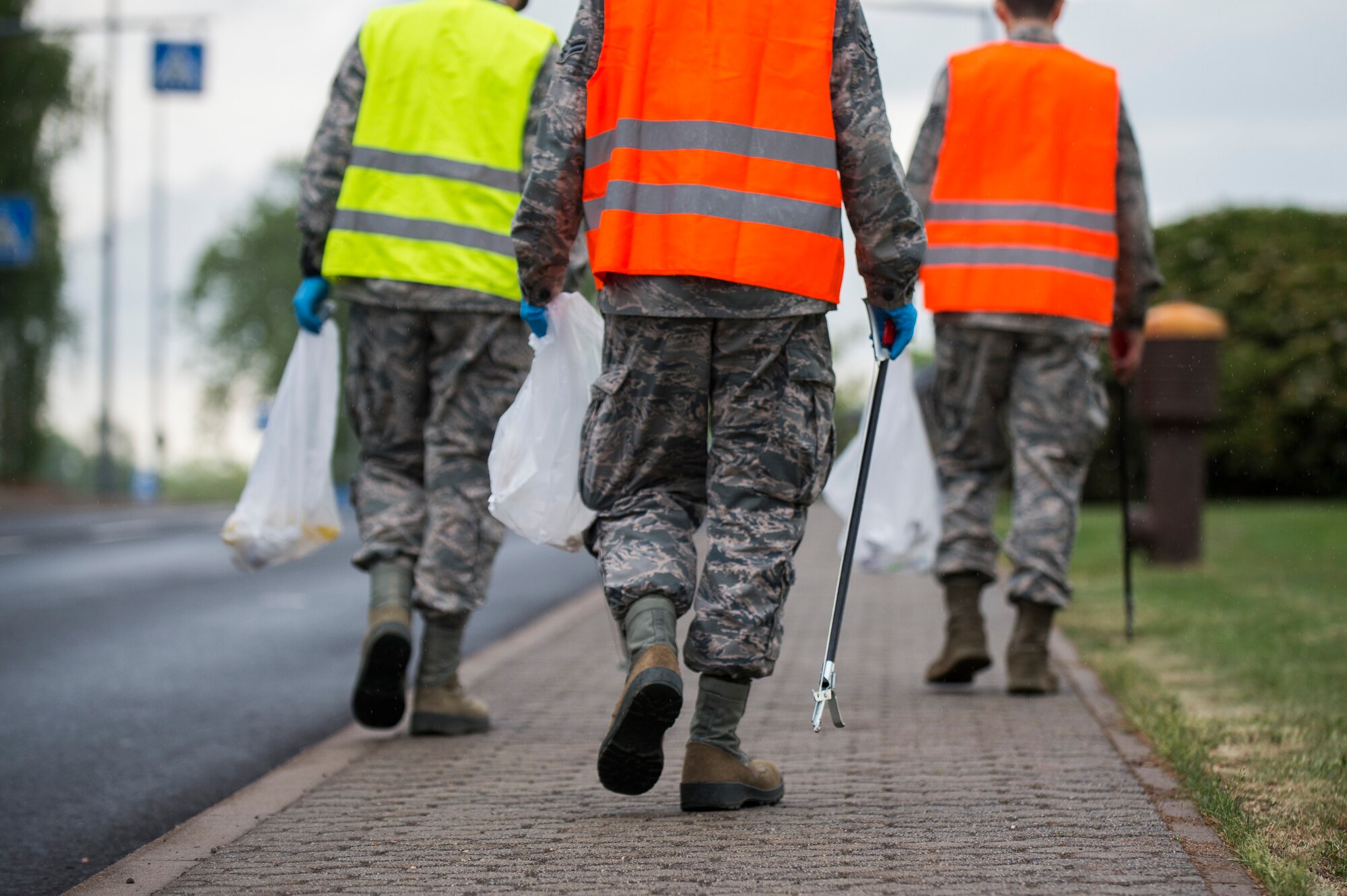 Airmen participating in Spangdahlem's Eifel Pride Program search for trash during a base cleanup at Spangdahlem Air Base, Germany, May 18, 2017. The two week program improves base appearance while also allowing Spangdahlem’s first-term Airmen to in-process and become more familiar with their new duty station. (U.S. Air Force photo by Senior Airman Preston Cherry)