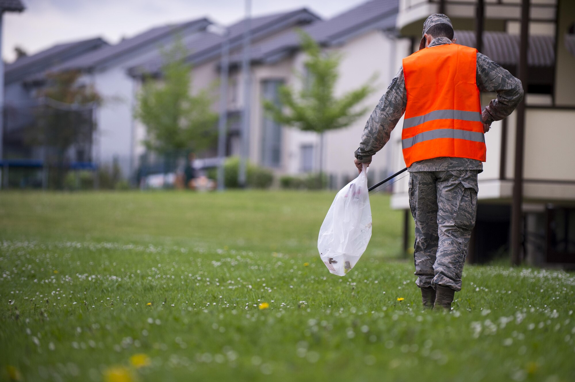 Airman Michael Agostino, 52nd Communications Squadron client systems technician, picks up trash during Spangdahlem's Eifel Pride base cleanup at Spangdahlem Air Base, Germany, May 18, 2017. The two-week program improves base appearance while also allowing Spangdahlem’s first-term Airmen in-process and become familiar with their new duty station. (U.S. Air Force photo by Senior Airman Preston Cherry)