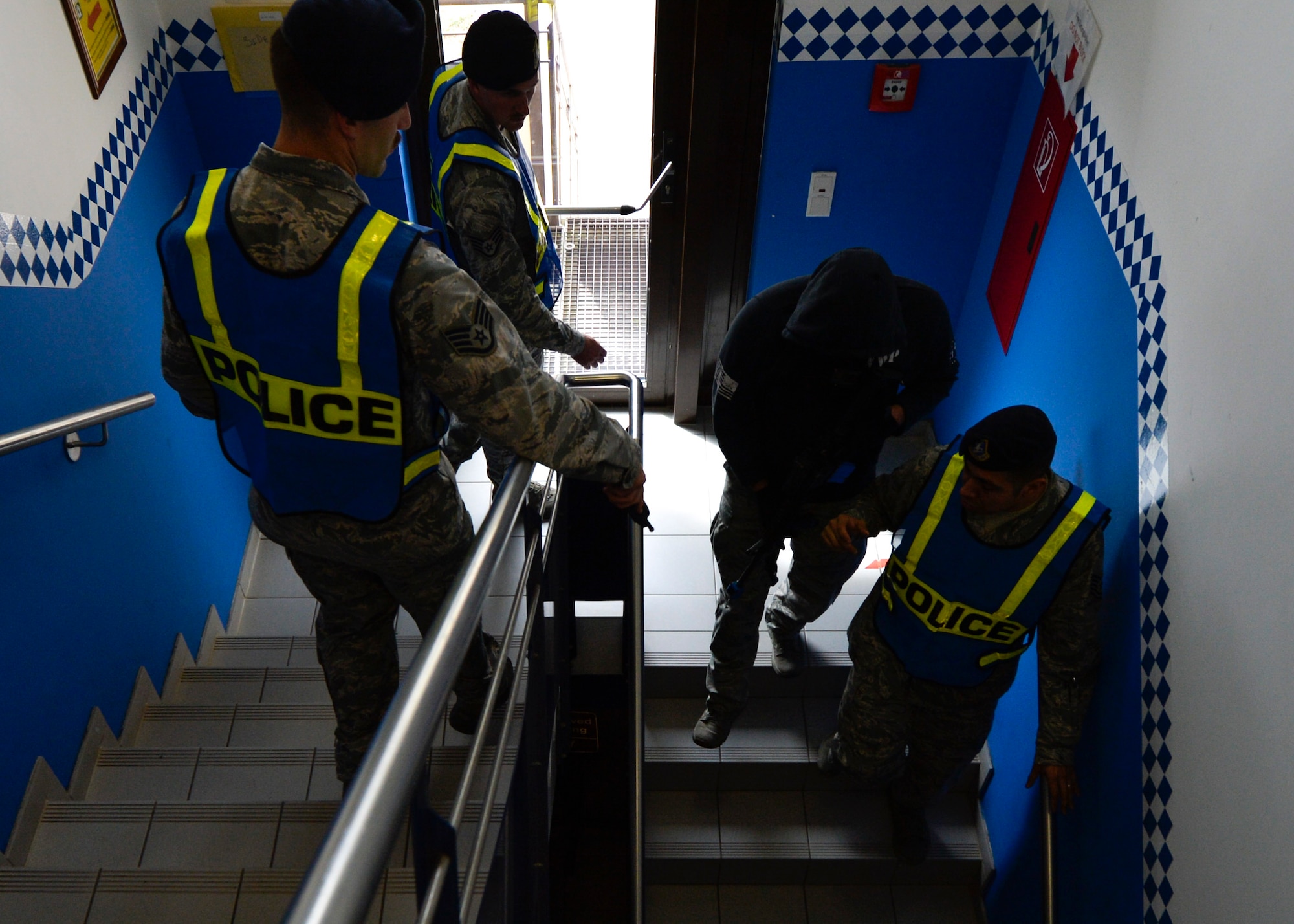 Airmen from the 86th Security Forces Squadron prepare during an active shooter readiness training at the 86th Maintenance Group on Ramstein Air Base, Germany, July 12, 2017.  Approximately 15 key players worked directly with the 86th MXG readiness and training cell facilitate the exercise and ensure safety. (U.S. Air Force photo by Staff Sgt. Nesha Humes)