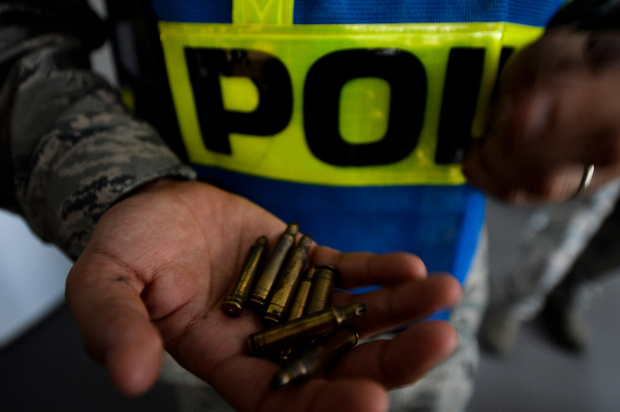 U.S. Air Force Tech Sgt. Steve Albvenra, 86th Security Forces noncommissioned officer in-charge of training, collects shell casings during an active shooter readiness training at the 86th Maintenance Group on Ramstein Air Base, Germany, July 12, 2017. Airmen from the 86th SFS fired blank ammunition during the readiness training in order to appeal to Airmen’s senses and highlight the importance of using a critical thought process during emergency situations. (U.S. Air Force photo by Staff Sgt. Nesha Humes)