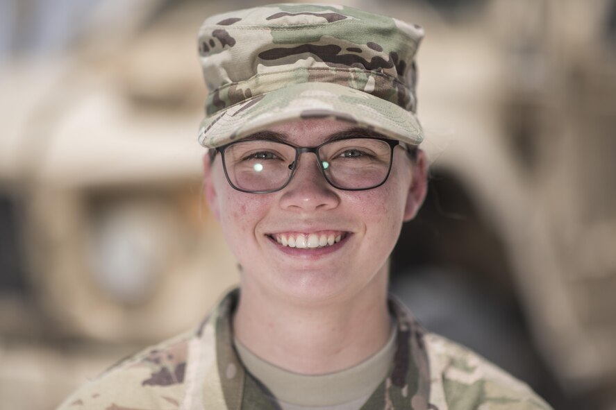 Senior Airman Sela Goodman, 332nd Expeditionary Security Forces Squadron intelligence analyst, stands in front of a mine-resistant ambush protected all-terrain vehicle July 10, 2017, in Southwest Asia. Goodman is one of a few Airmen assigned to the 332nd ESFS as an intelligence analyst. (U.S. Air Force photo/Senior Airman Damon Kasberg)  