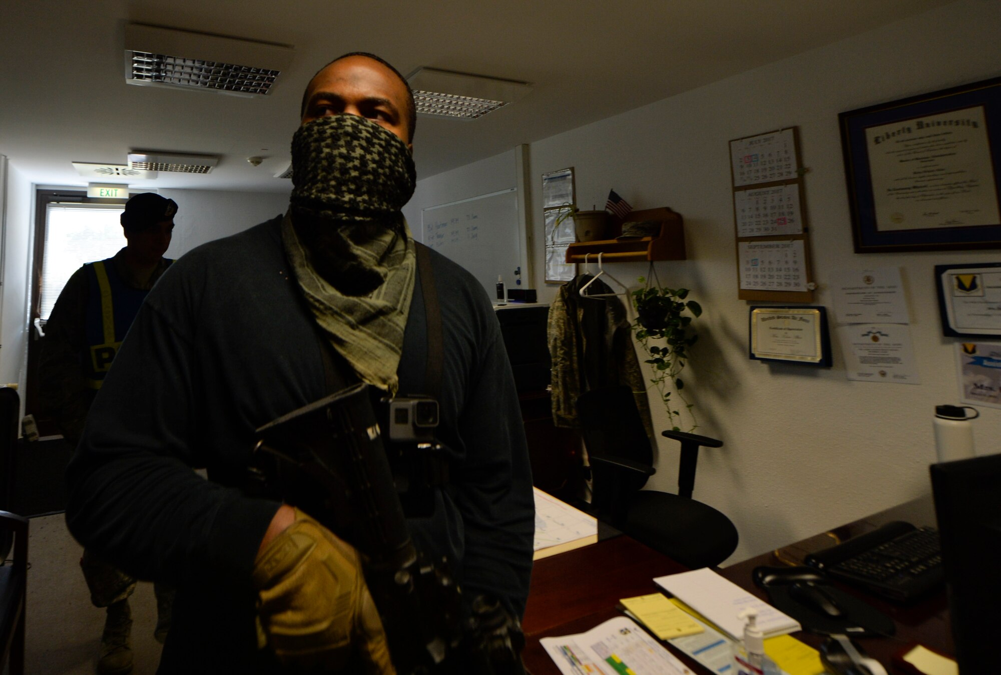 U.S. Air Force Staff Sgt. Antonio Lofton, 86th Security Forces Squadron instructor, simulates being an active shooter during an exercise at the 86th Maintenance Group on Ramstein Air Base, Germany, July 12, 2017. Multiple organizations such as command post and security forces are notified prior to the exercise to practice emergency procedures. (U.S. Air Force photo by Staff Sgt. Nesha Humes)