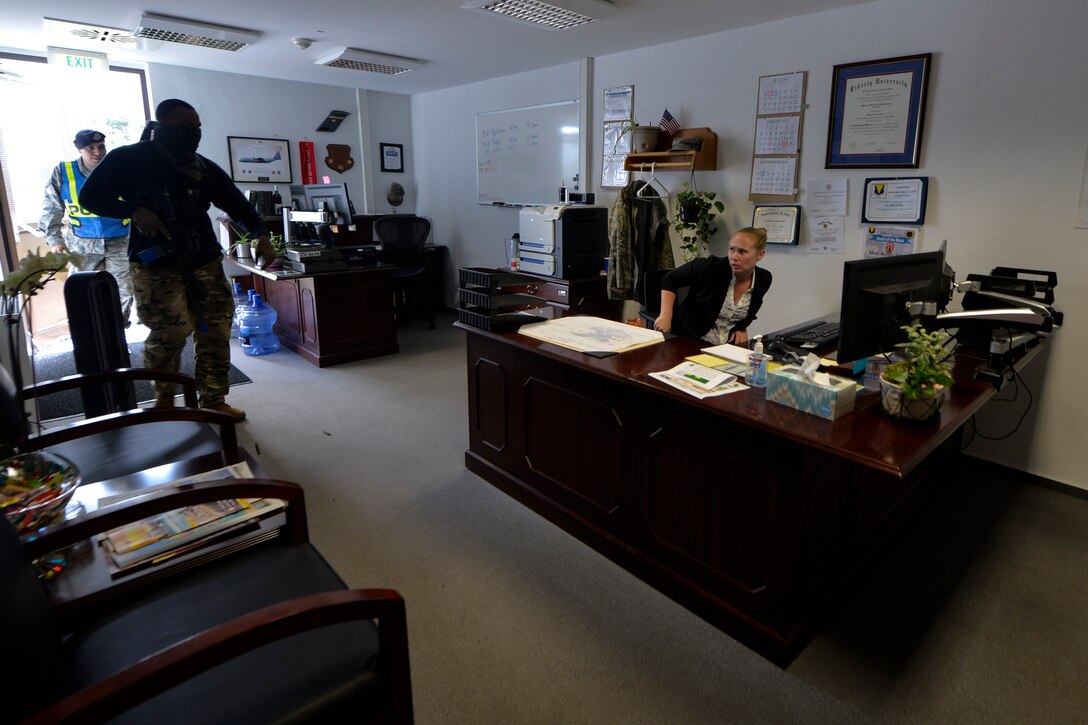U.S. Air Force Staff Sgt. Antonio Lofton, 86th Security Forces Squadron instructor and Keira Allen, 86th Maintenance Group commander executive assistant, yell and react during an active shooter exercise at the 86th MXG on Ramstein Air Base, Germany, July 12, 2017. Airmen from the 86th SFS fired blank ammunition during the readiness training in to highlight the importance of using a critical thought process during emergency situations by appealing to their senses.  (U.S. Air Force photo by Staff Sgt. Nesha Humes)