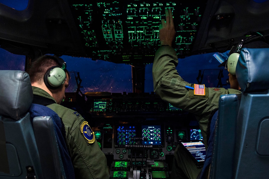Air Force Maj. Timothy Birt and Capt. Greg Sewell conduct pre-flight checks inside the cockpit of a C-17 Globemaster III on the ramp at Joint Base Elmendorf-Richardson, Alaska, July 12, 2017, before takeoff to participate in Exercise Talisman Saber 2017. Birt and Sewell are pilots assigned to the 15th Airlift Squadron, deployed from Joint Base Charleston, S.C. Air Force photo by Tech. Sgt. Gregory Brook