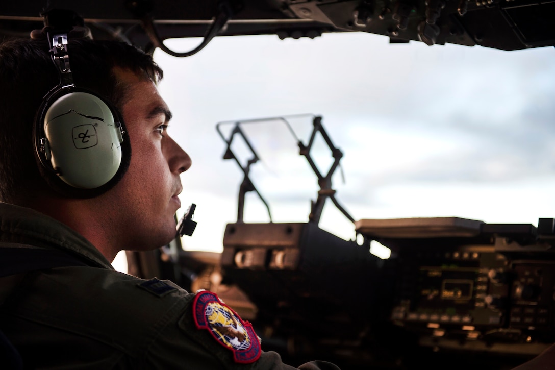 Air Force Capt. Eric Lomelli looks out from a C-17 Globemaster III over the Pacific Ocean, July 12, 2017, enroute to Australia to participate in Exercise Talisman Saber 2017. Lomelli is a pilot assigned to the 15th Airlift Squadron, deployed from Joint Base Charleston, S.C. Air Force photo by Tech. Sgt. Gregory Brook