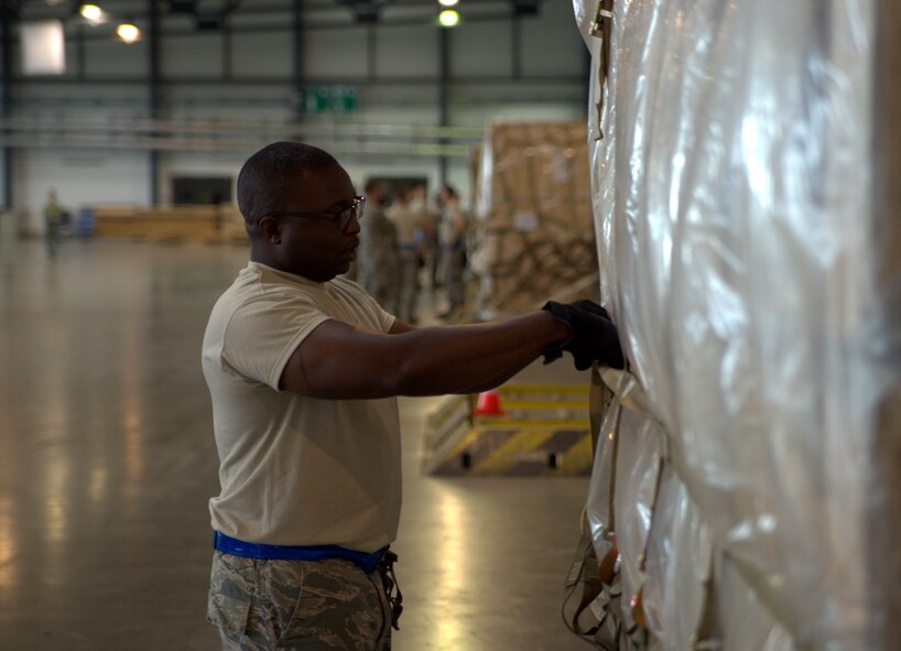 Tech. Sgt. Curtis Priester, a Citizen Airman with JB Charleston's 81st Aerial Port Squadron, secures nets on palletized cargo at the Ramstein Air Base Aerial Port, July 12, 2017.  Reservists from Charleston conducted two weeks of annual training at Ramstein AB in order to help ensure operational readiness. (U.S. Air Force photo by Senior Airman Jonathan Lane)
