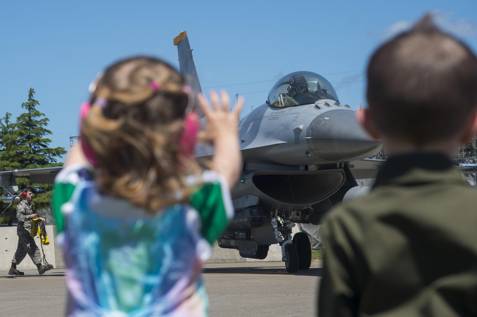 Family members of 35th Fighter Wing pilots welcome their loved ones as they return home from a temporary duty location at Misawa Air Base, Japan, June 26, 2017. The 13th Fighter Squadron and 35th Maintenance Group personnel trained with Airmen from Kunsan Air Base, South Korea, while the flightline underwent routine maintenance. During their tenure at Kunsan AB, 35th FW pilots enhanced readiness capabilities while training in unfamiliar territories with our allies within the Pacific Air Forces region. (U.S. Air Force photo/Senior Airman Deana Heitzman)