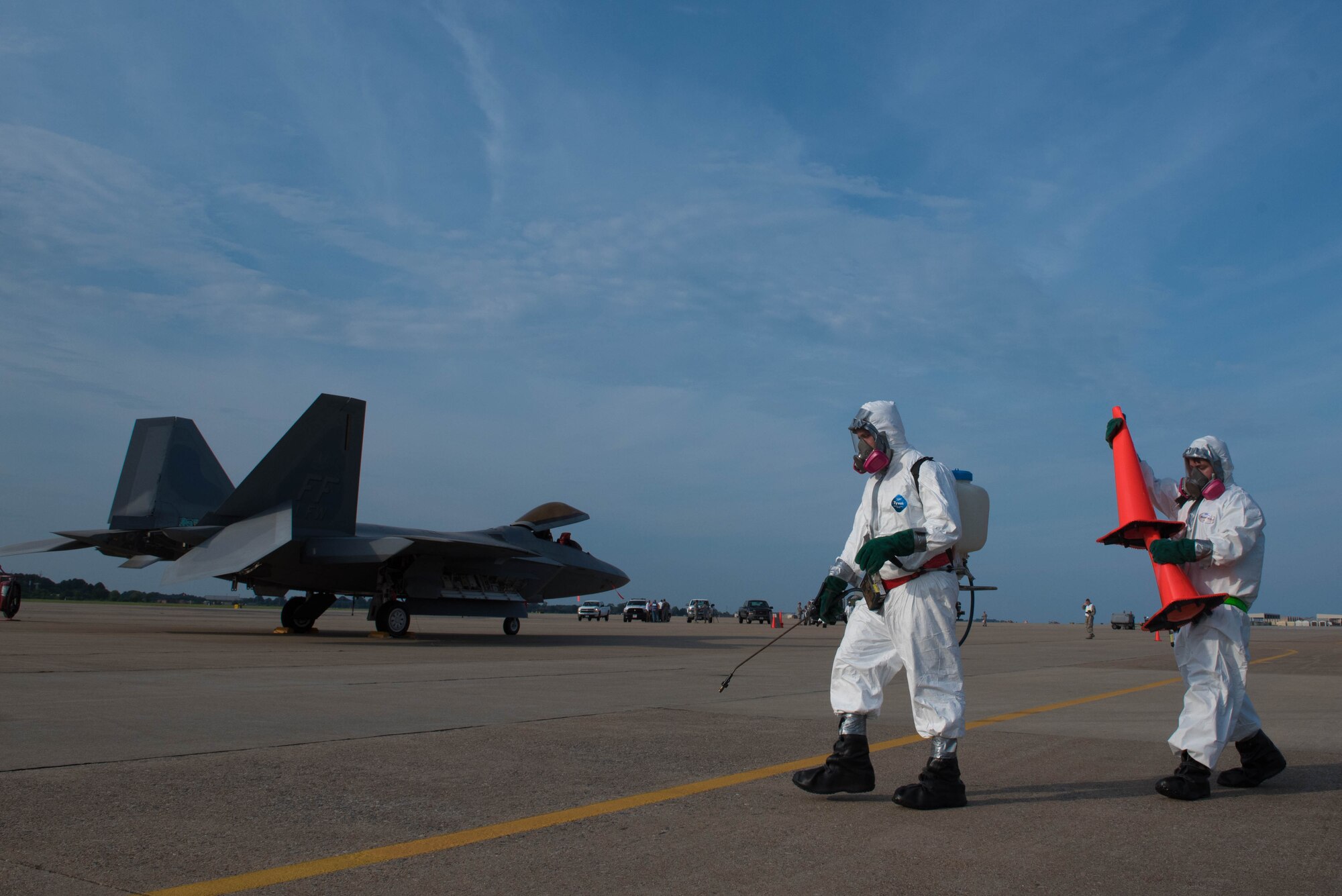 Joint Base Langey-Eustis 633rd Aerospace Medicine Squadron bio-environmental technicians simulate decontaminating a cordoned area during an aircraft incident exercise at Joint Base Langley-Eustis,Va., July 11, 2017. The exercise was used to inspect and evaluate base capabilities, while also allowing Airmen to learn from their mistakes, better preparing them for real-world scenarios. (U.S. Air Force photo/Staff Sgt. Carlin Leslie)