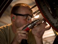 Airman 1st Class Greg Hildenbrandt, 86th Maintenance Squadron aircraft structural maintenance journeyman, repairs a crack in a C-130J Super Hercules engine at the 86th MXS Isochronal Dock on Ramstein Air Base, Germany, July 12, 2017. The personnel who support the Isochronal Dock come from specialties such as repair and reclamation, aircraft structural maintenance, aircraft metals technology, nondestructive inspection, aerospace propulsion, communication and navigation systems, and guidance and control systems. (U.S. Air Force photo by Senior Airman Elizabeth Baker)