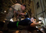 Staff Sgts. Andrew Jean, right, and Jacob Law, 86th Maintenance Squadron repair and reclamation craftsmen, inspect a C-130J Super Hercules for wear and tear at the 86th MXS Isochronal Dock on Ramstein Air Base, Germany, July 12, 2017. Repair and reclamation personnel are some of the many specialists who team up to keep Ramstein’s fleet in top condition so that aircrews can fly safely and focus on the mission. (U.S. Air Force photo by Senior Airman Elizabeth Baker)