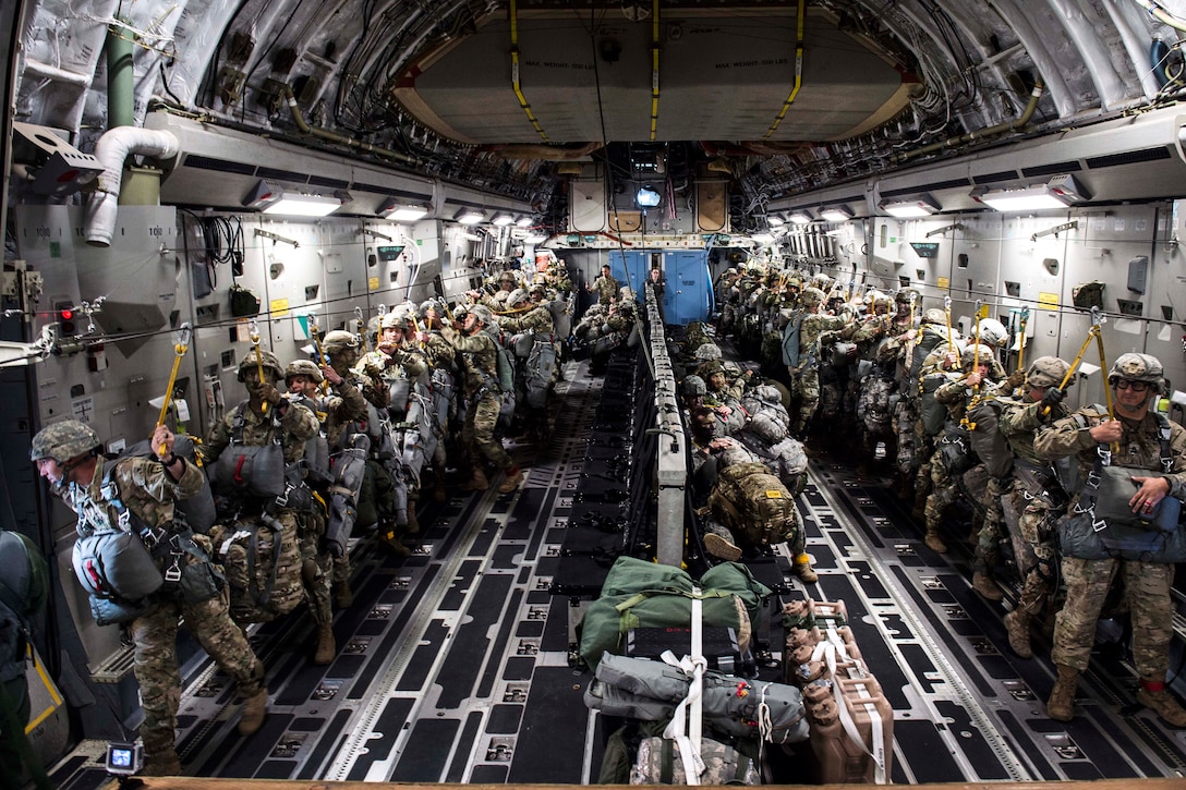 U.S. and Canadian paratroopers stand-up and hook-up inside a C-17 Globemaster III, July 12, 2017, before conducting airborne operations while participating in Exercise Talisman Saber 2017. Air Force photo by Tech. Sgt. Gregory Brook