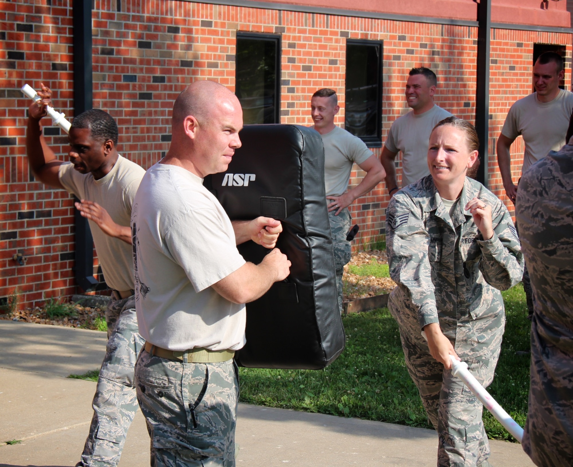 Drill weekends are always busy at the 932nd Airlift Wing as reservists come to the Illinois unit from 37 states.  Here, the 932nd Security Forces Squadron Airmen, with protective shields, brace for impact from pressure applied by fellow squadron member during a baton blocking and attacking training class, at Scott Air Force Base, Illinois, June 4, 2017.   Several people later volunteered to be in the highly padded "RedMan suit" to better appreciate the mission and importance of the 932nd AW SFS team. It was all about training, unit bonding, and outdoor crowd control and aggressor experience. (U.S. Air Force photo by Lt. Col. Stan Paregien)