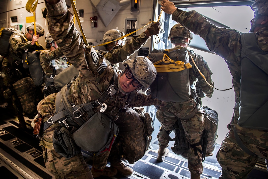 U.S. and Canadian paratroopers prepare to jump from a C-17 Globemaster III, July 12, 2017, while conducting airborne operations in Exercise Talisman Saber 2017. Air Force photo by Tech. Sgt. Gregory Brook