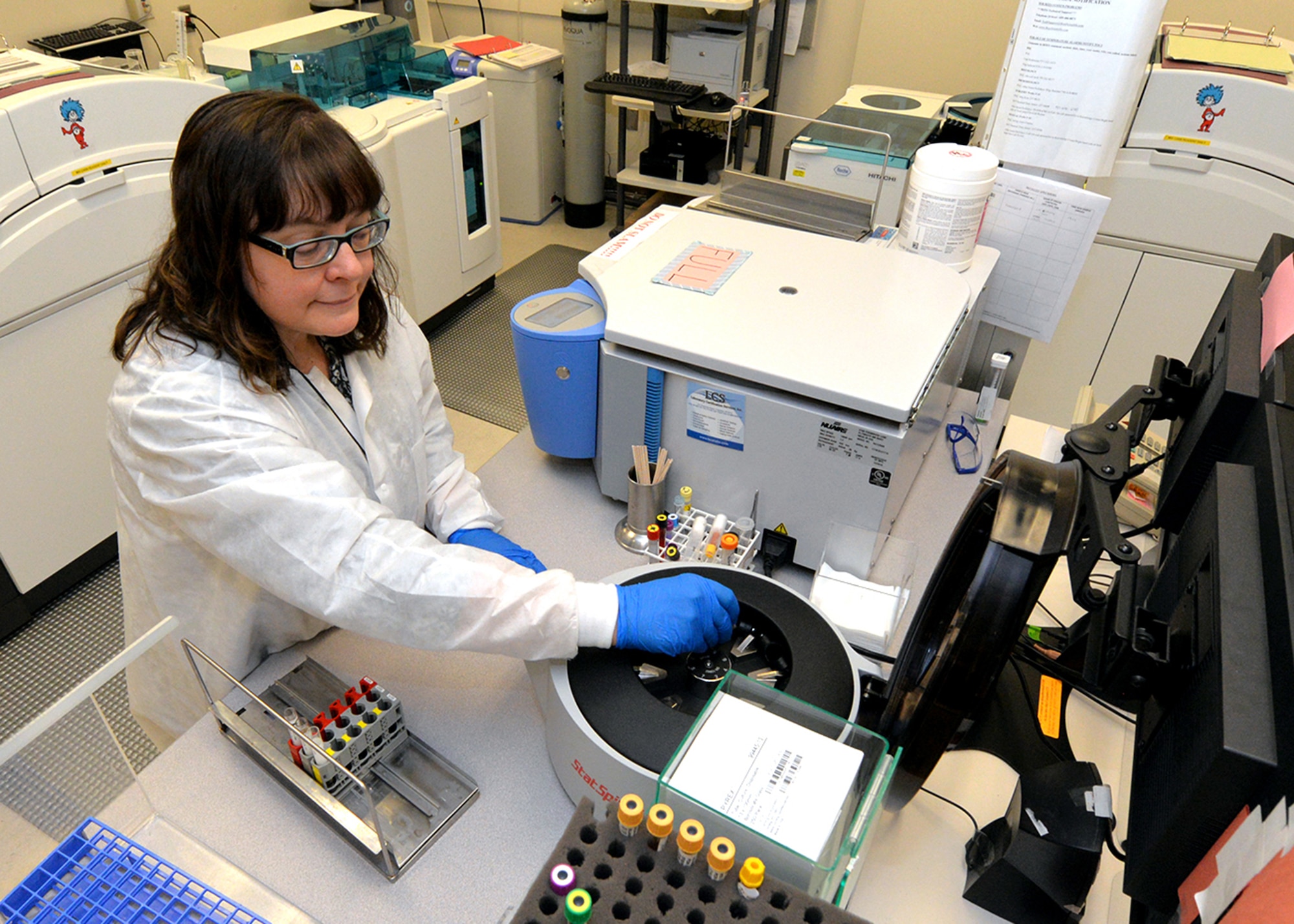 Bonnie Lofthouse, 88th Diagnostics and Therapeutics Squadron lab flight medical technician, performs routine patient blood sample testing using the Cobas 6000 chemical analyzer at the Wright-Patterson AFB hospital laboratory May 15, 2017. The Cobas 6000 gives quick turnaround accurate testing results to medical professionals enabling them to provide optimal patient care. (U.S. Air Force photo by Al Bright)