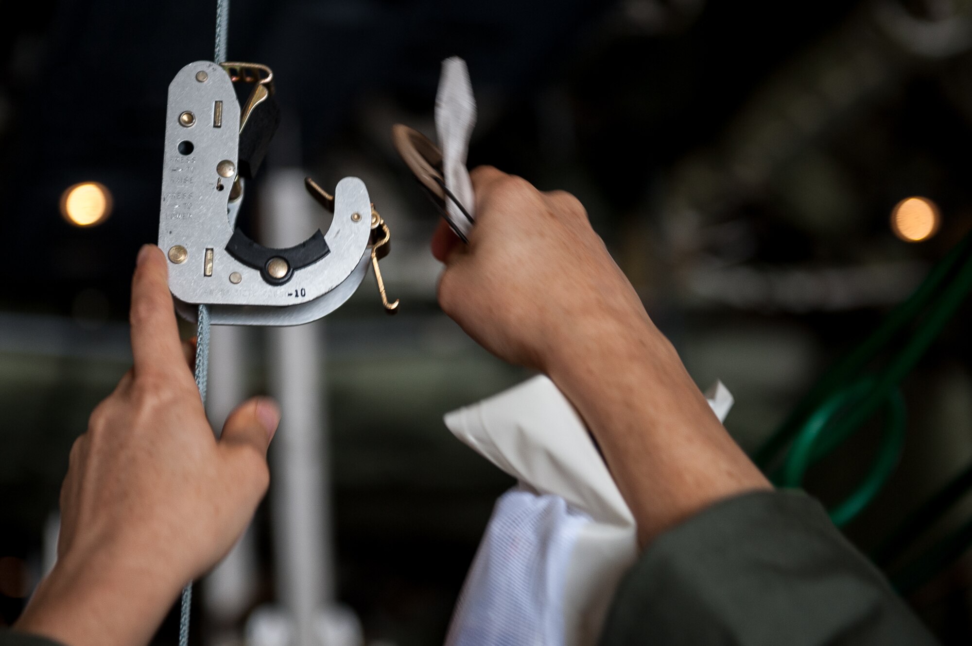 A U.S. Air Force Airman assigned to the 86th Medical Group attaches an IV drip to the inside of a C-130J Super Hercules during a training exercise on the flightline on Ramstein Air Base, Germany, July 12, 2017. The training exercise required extensive knowledge of the aircraft in order to properly secure the patients for transport. (U.S. Air Force photo by Senior Airman Devin Boyer)