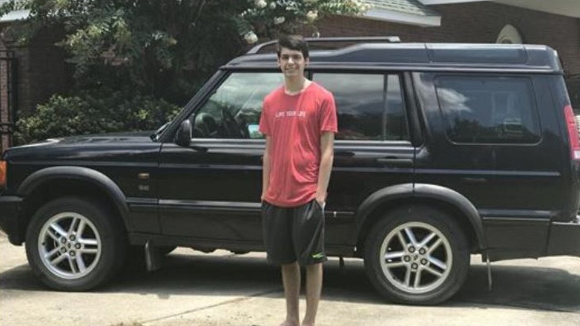 Anthony Balmer, son of Air Force Office of Special Investigations Fallen Special Agent Ryan Balmer, poses with the 2003 Land Rover his father drove prior to his death in 2007. Anthony's mother, Danielle, put the vehicle in storage until Anthony turned 18 when she gave it to him. (Courtesy photo)    