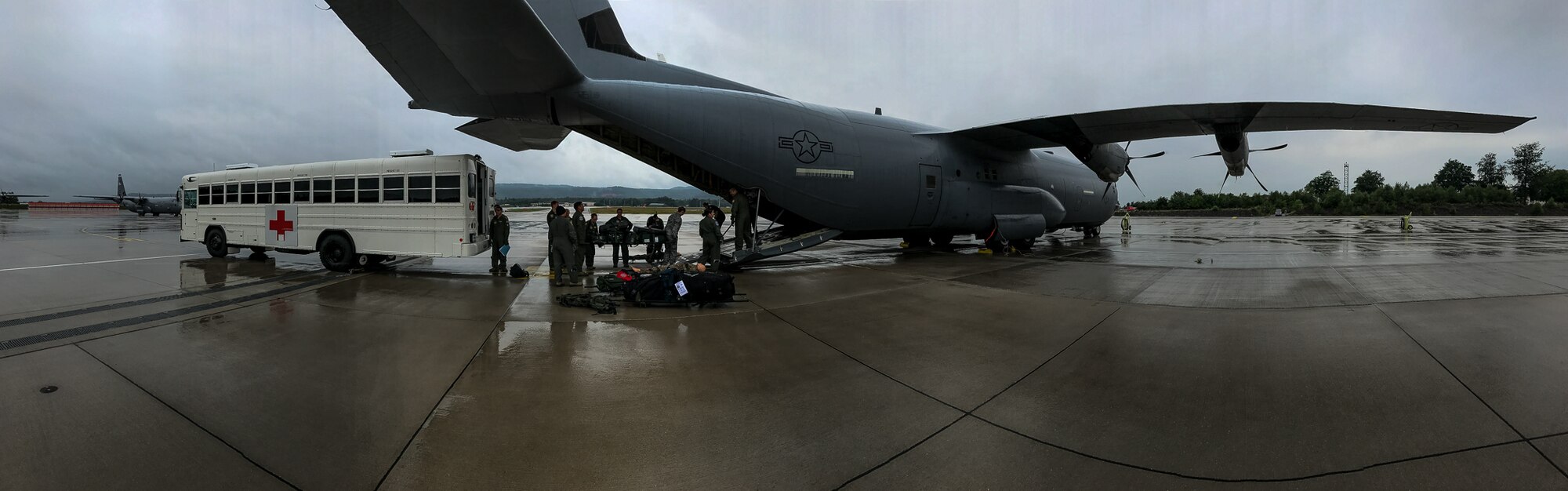 U.S. Air Force Airmen assigned to the 86th Medical Squadron’s Critical Care Air Transportation Team and 86th Aeromedical Evacuation Squadron transport mannequin patients from a bus to a C-130J Super Hercules during a training exercise on the flightline on Ramstein Air Base, Germany, July 12, 2017. Despite the inclement weather, the Airmen pressed forward with the training as they would with real world scenarios. (U.S. Air Force photo by Senior Airman Devin Boyer)