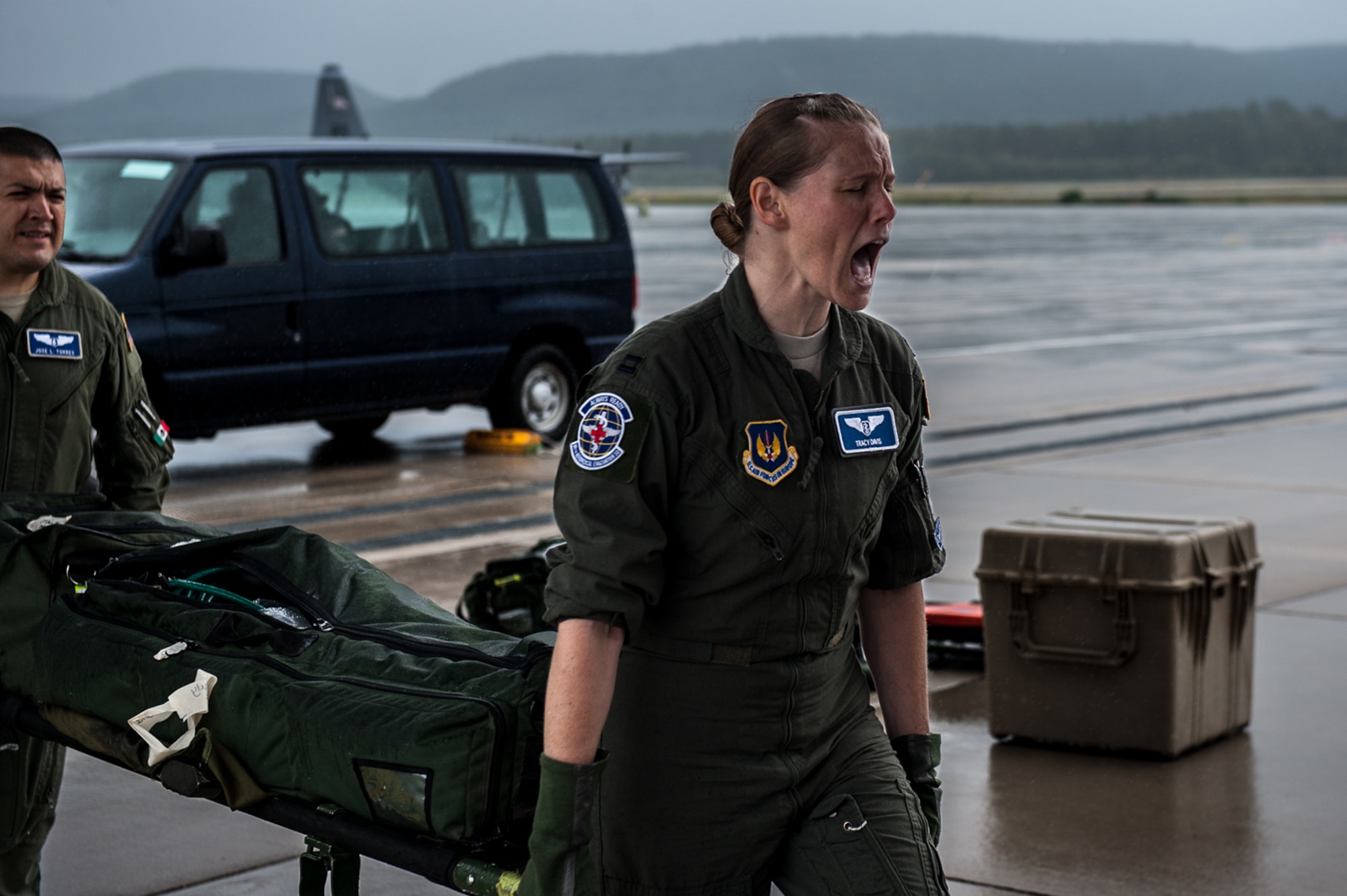 U.S. Air Force Capt. Tracy Davis, 86th Aeromedical Evacuation Squadron mission management element leader, shouts to her crew to clear a path while carrying a litter with Capt. Jose Torres, 86th AES standards and evaluation liaison officer, during a training exercise on the flightline on Ramstein Air Base, Germany, July 12, 2017. The 86th Medical Squadron Critical Care Air Transportation Team and 86th AES team worked together to transport critical care patients from the scene to the aircraft, and from the aircraft to Landstuhl Regional Medical Center. (U.S. Air Force photo by Senior Airman Devin Boyer)