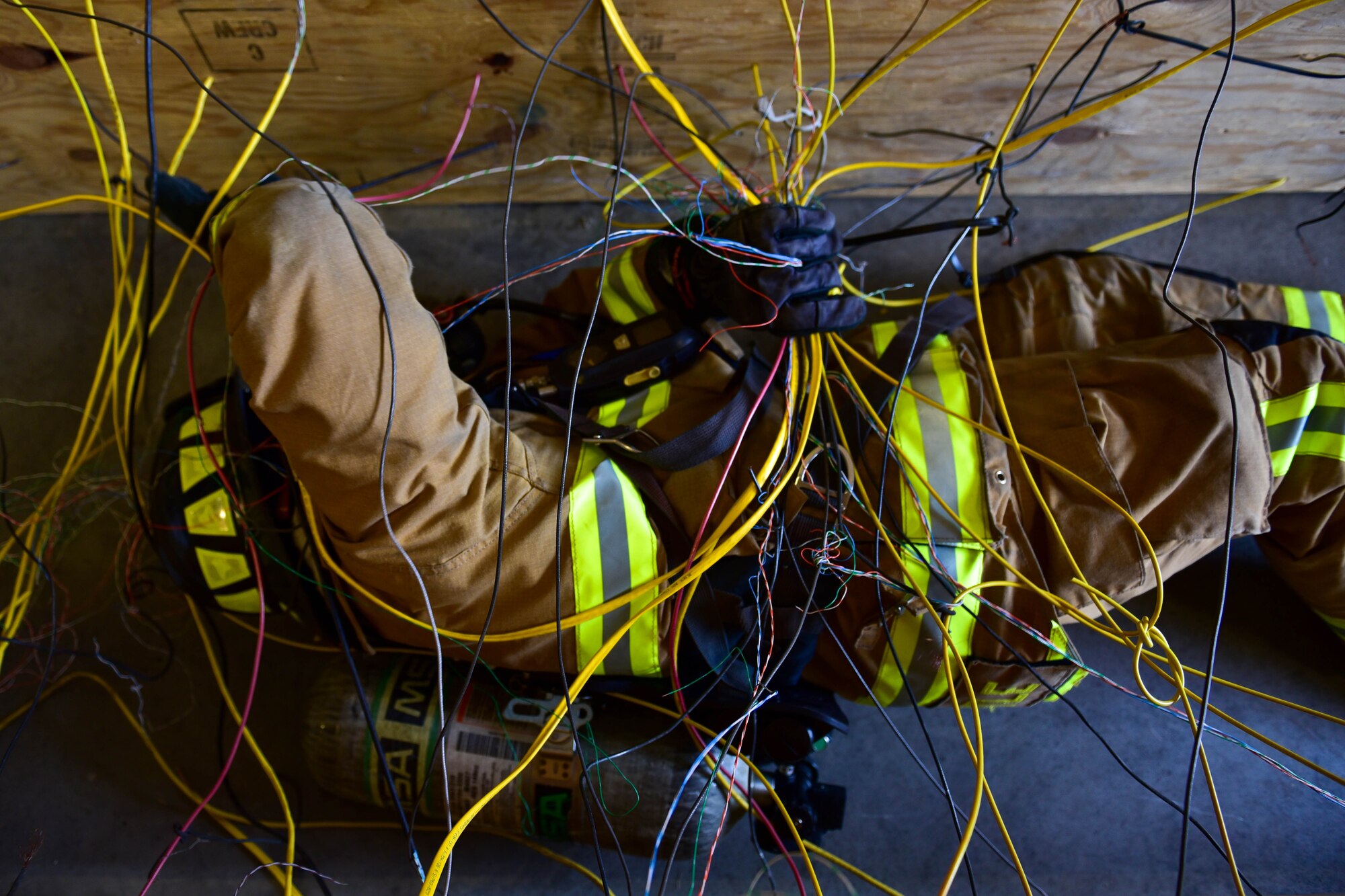 An Air Force Firefighter navigates through a simulated roof collapse during a 5 day training course hosted by Niagara Falls Air Reserve Station, N.Y., July 12, 2017. Participants come from Mcguire, Dix-lakehurst, Fairchild, Dover, MacDill, and Grissom as well as Niagara. The course offers hands-on training for emergency situations in preparation of real-world situations. (U.S. Air Force photo by Staff Sgt. Richard Mekkri) 