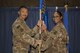 Col. Christopher K. Fuller, 332nd Expeditionary Mission Support Group commander, left, passes the guidon to Maj. Lydia A. Bradley-Tyler, during the 332nd Expeditionary Force Support Squadron assumption of command ceremony July 13, 2017, in Southwest Asia. The passing of a guidon symbolizes a unit’s transfer of command. (U.S. Air Force photo/Senior Airman Damon Kasberg)