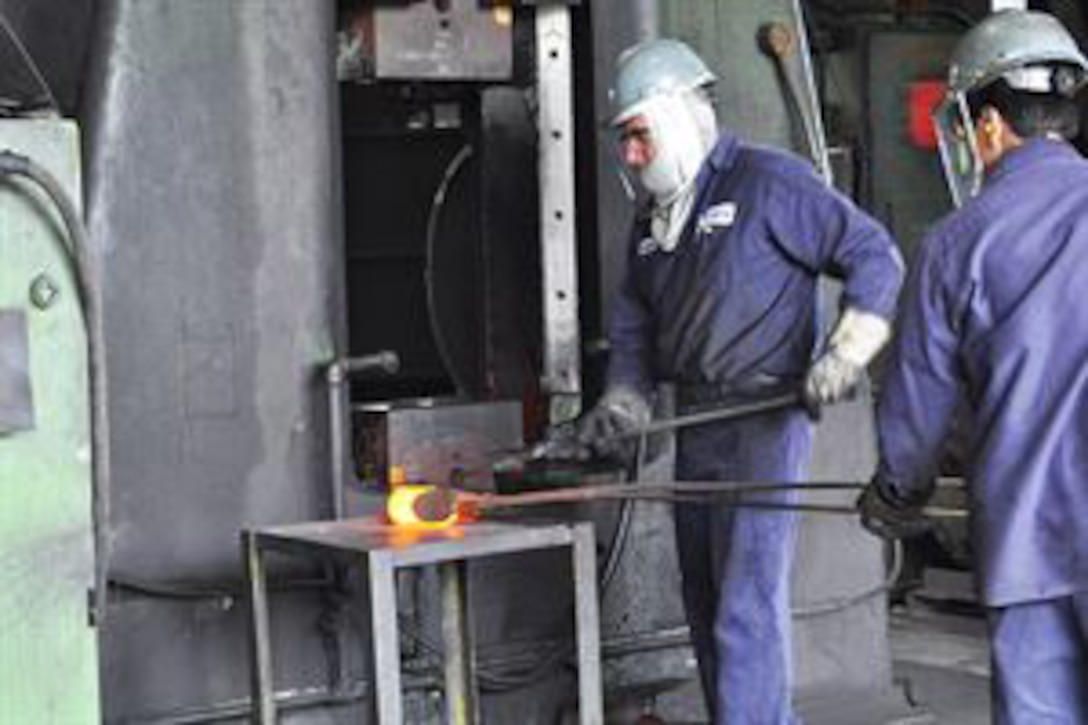 A foundry worker demonstrates forging a metal part during a two-day seminar for DLA Aviation Forging and Casting team members at the U.S. Drop Forge Co. in Woolwich Township, New Jersey.