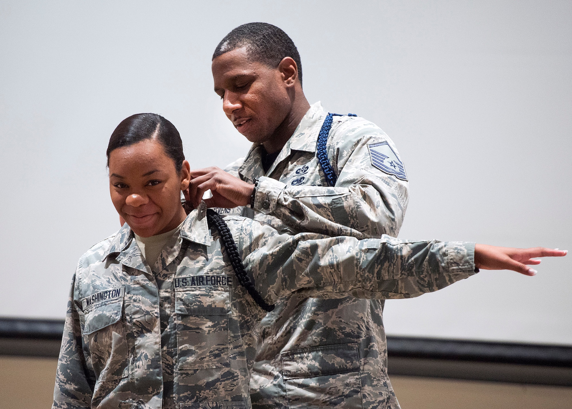 Master Sgt. Michael J. Stevens, United States Air Force School of Aerospace Medicine Military Training Flight chief, pins on Airman Chiara Washington the black rope signifying her as a member of the school’s drill team July 7, 2017 on Wright-Patterson Air Force Base, Ohio. Stevens, was named as one of the Air Force’s 12 Outstanding Airmen of the Year. (U.S. Air Force photo by R.J. Oriez)