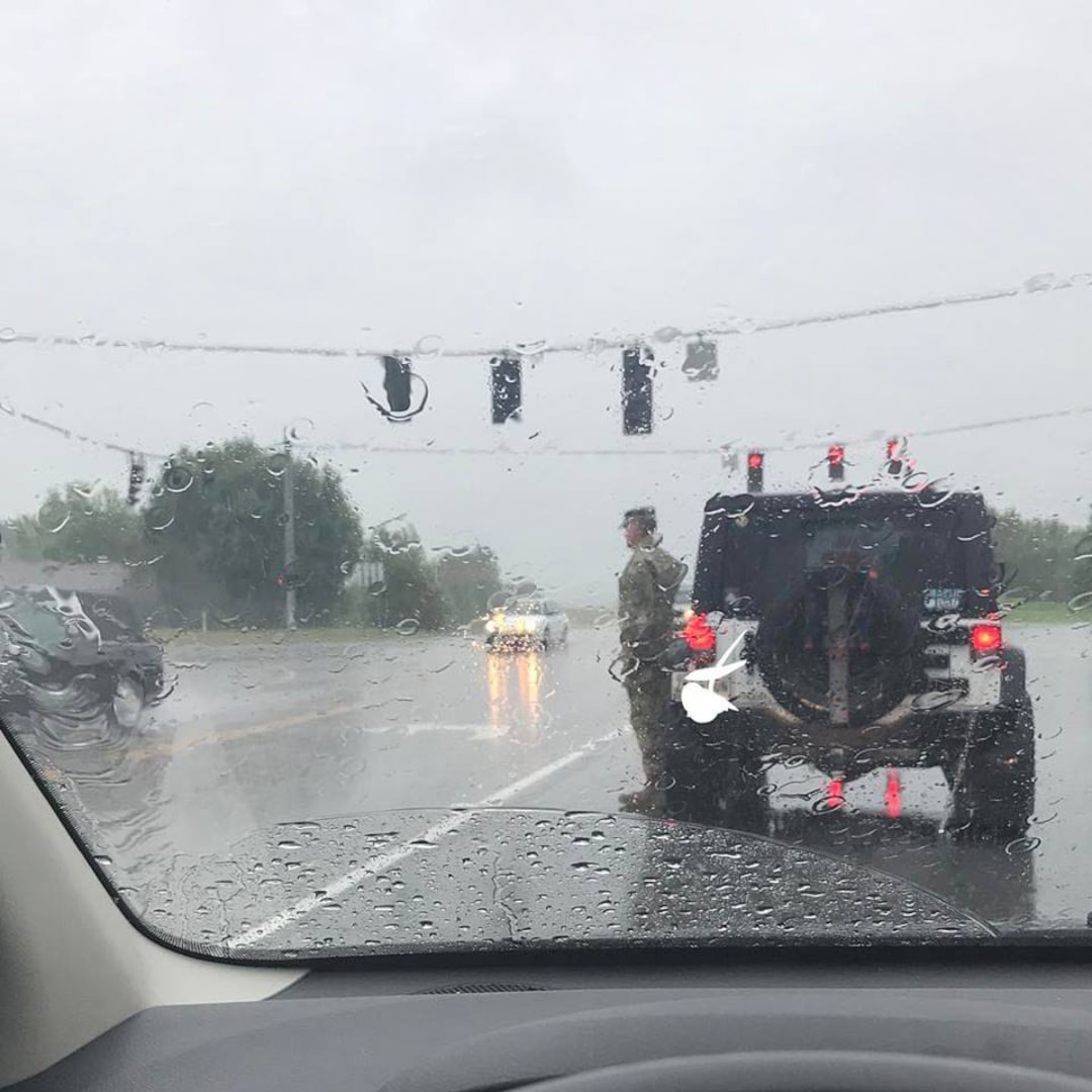 Tennessee National Guard Col. Jack Usrey pulled his vehicle over and saluted a passing funeral procession in this photo that went viral on the internet. He was subsequently identified and spoke by phone to the woman who snapped his photo on July 6, 2017.