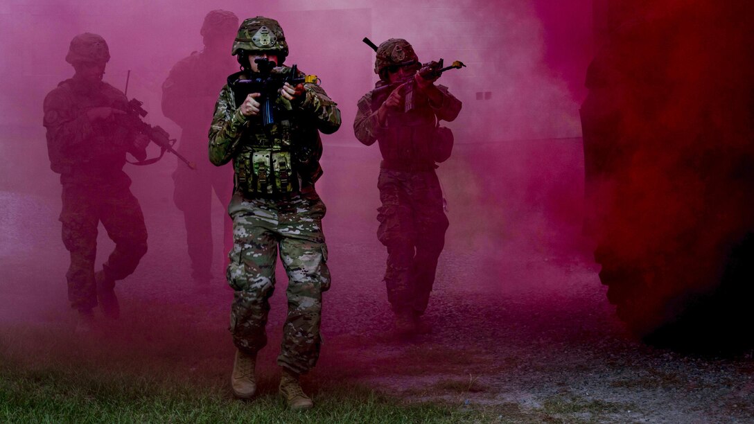 Airmen move through smoke used for cover during a combat simulation at Moody Air Force Base, Ga., July 11, 2017. The airmen are assigned to the 823rd Base Defense Squadron, which was giving a demonstration of its capabilities to Chief Master Sgt. David Wade, the 9th Air Force command chief. Air Force photo by Staff Sgt. Eric Summers Jr.