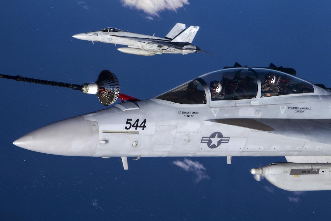 A Navy EA-18G Growler receives fuel from a Royal Australian Air Force KC-30 as a Navy F/A-18E Super Hornet flies nearby awaiting fueling over the Coral Sea, July 12, 2017, during exercise Talisman Saber 17. Talisman Saber is a U.S.-Australian training activity designed to improve combat readiness and interoperability. Royal Australian Air Force photo
