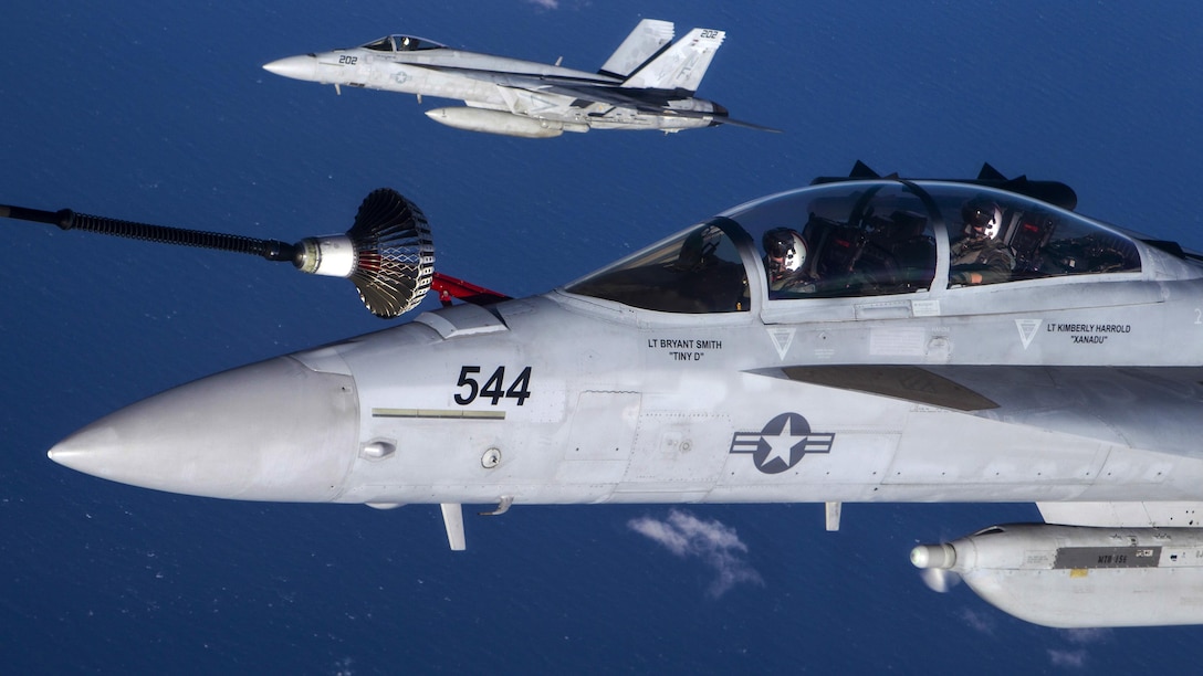 A Navy EA-18G Growler receives fuel from a Royal Australian Air Force KC-30 as a Navy F/A-18E Super Hornet flies nearby awaiting fueling over the Coral Sea, July 12, 2017, during exercise Talisman Saber 17. Talisman Saber is a U.S.-Australian training activity designed to improve combat readiness and interoperability. Royal Australian Air Force photo
