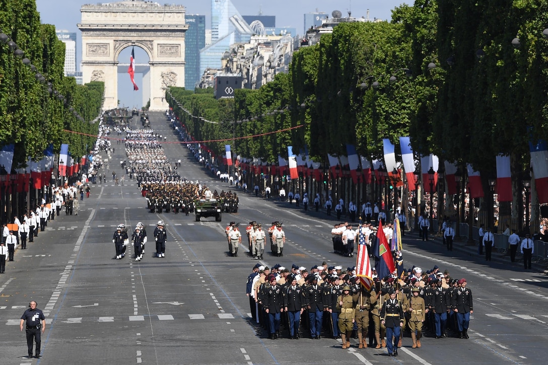 Almost 200 U.S. soldiers, sailors, Marines and airmen march down the Champs-Elysees from the Arc de Triomphe to the Place de la Concorde during the Bastille Day military parade in Paris, July 14, 2017. Navy photo by Chief Petty Officer Michael McNabb
