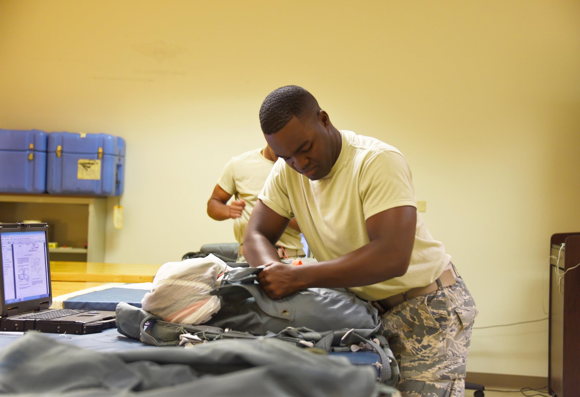 Airman Christopher Jackson, 361st Training Squadron aircrew flight equipment apprentice student packs the Back Automatic 22 style parachute at Sheppard Air Force Base, Texas. In this course students ensure that all flight and safety equipment is in perfect working order. (U.S. Air Force photo/Liz H. Colunga)

