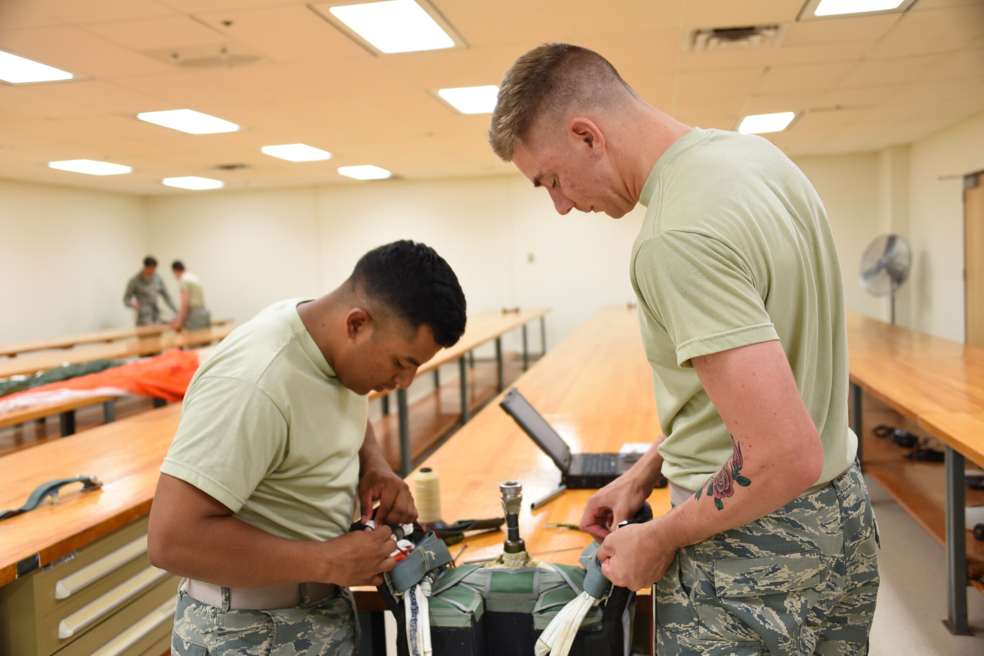 Airmen Christian Mejia-Mendoza and David Renahan, 361st Training Squadron aircrew flight equipment apprentice students ensure that all flight and safety equipment is in perfect working order at Sheppard Air Force Base, Texas.at Sheppard Air Force Base, Texas. In this course students learn to recover, assemble, inspect and pack the ACES II Recovery parachute. This parachute system is stowed behind the crewman’s seat headrest and is projected after the ejection seat is projected from the F-16 aircraft.  (U.S. Air Force photo/Liz H. Colunga)