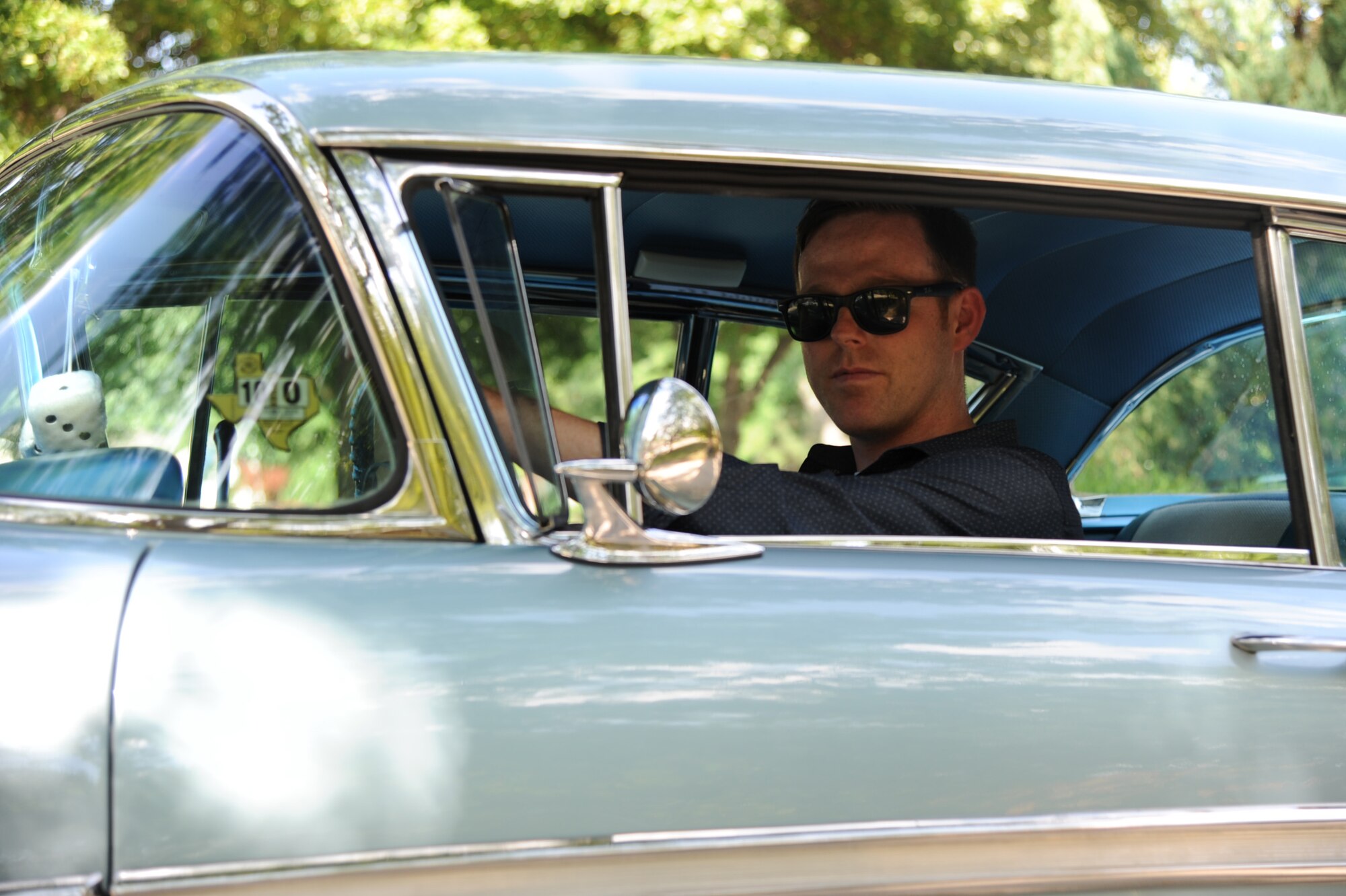 Master Sgt. Bobby McCrary, 22nd Force Support Squadron NCO in-charge of Honor Guard, poses for a photo in his 1958 Chevy Impala, July 13, 2017, at his home in Derby, Kan. McCrary grew up going to car shows and swap meets with his grandfather, who rebuilt classic cars. (U.S. Air Force photo/Senior Airman Jenna K. Caldwell)